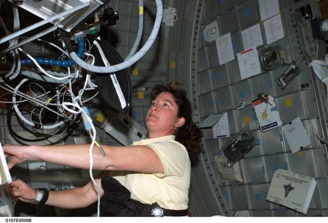 NASA image: Clark in the Spacehab RDM during activation of ARMS experiment equipment during STS-107