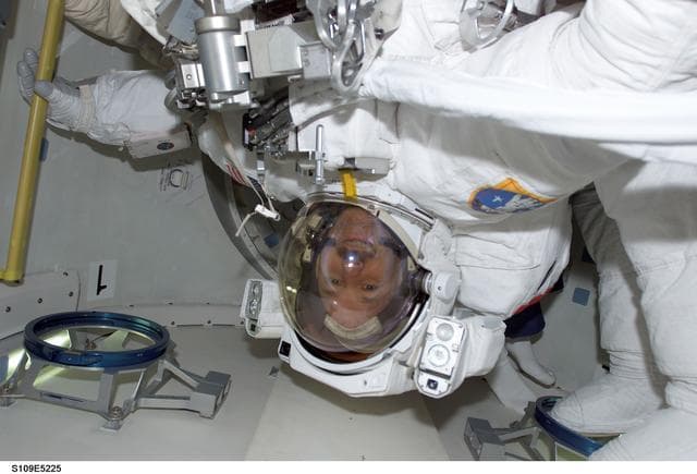 NASA image: STS-109 MS Grunsfeld  in airlock prior to EVA