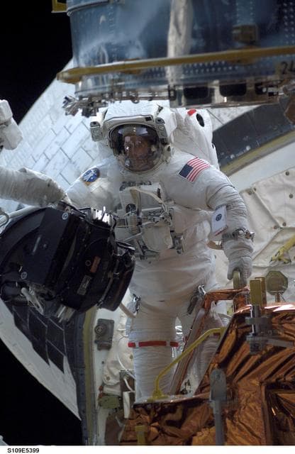 NASA image: STS-109 MS Newman replace Reaction Wheel assembly during EVA 2
