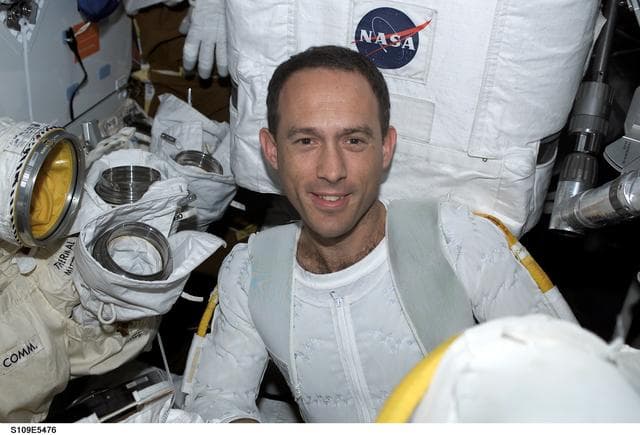 NASA image: STS-109 MS Newman prepares for EVA 4 on middeck