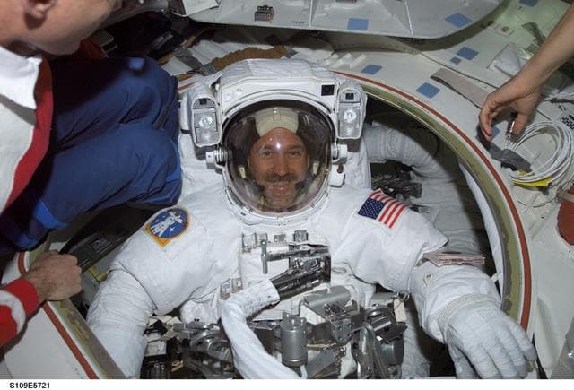 NASA image: MS Grunsfeld wearing EMU in Airlock