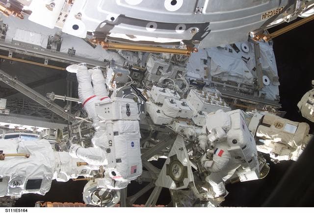 NASA image: Chang-Diaz and Perrin work at the MBS on the S0 (S-zero) truss during STS-111 UF-2 EVA 2