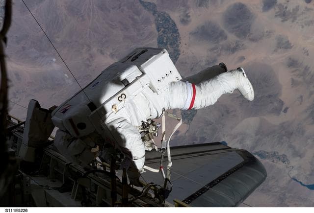 NASA image: Chang-Diaz translates Endeavour's port sill during STS-111 UF-2 EVA 2