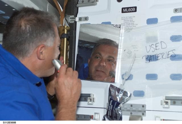 NASA image: MS Wolf shaves on middeck