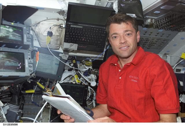 NASA image: STS-112 CDR Ashby at aft flight deck controls