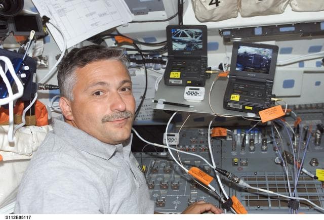 NASA image: STS-112  MS Yurchikhin on flight deck with video players