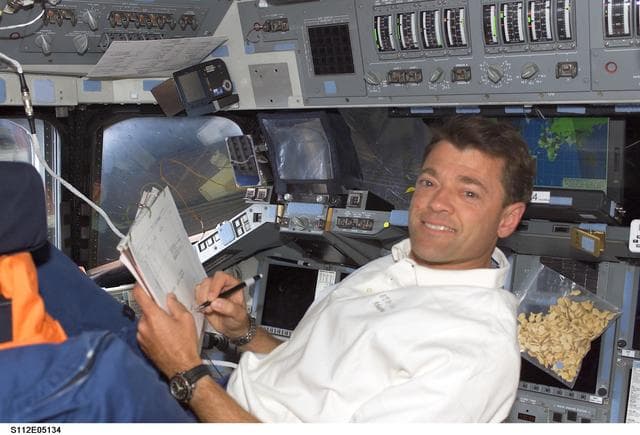NASA image: CDR Ashby on flight deck with checklist