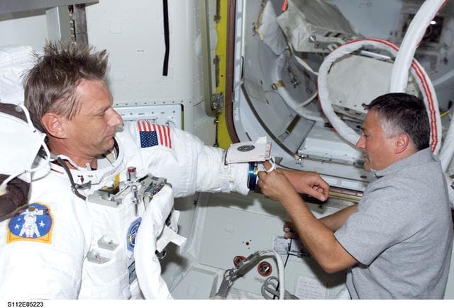 NASA image: MS Sellers prepares for EVA 2 with help from MS Yurchikhin
