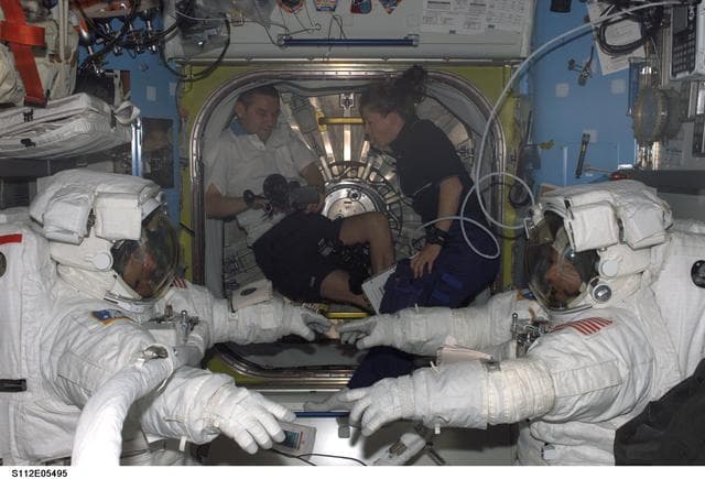 NASA image: MS Wolf and MS Sellers in Quest airlock for EVA 3
