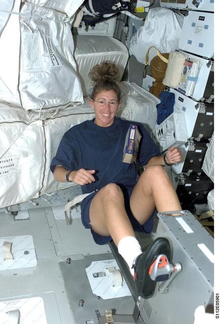 NASA image: STS-112 MS Magnus exercises on ergometer on middeck