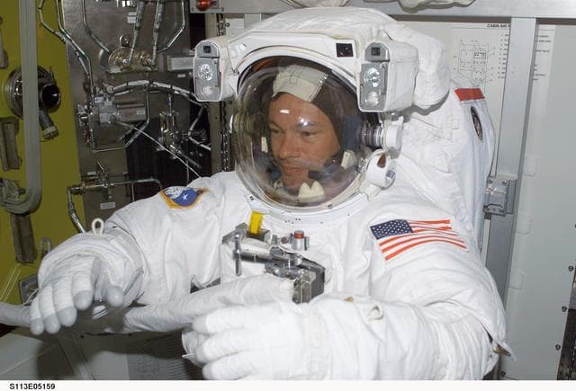 NASA image: EVA Prep OPS - MS Lopez-Alegria donned in EMU for first EVA during STS-113
