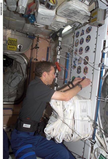 NASA image: Wetherbee places mission sticker on panel in Node 1 during STS-113 / EXP. 5