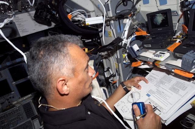 NASA image: Olivas uses communication equipment on the FD during Joint Operations