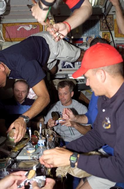 NASA image: Kotov, Olivas, Swanson, and Sturckow enjoy a meal in the SM during Joint Operations