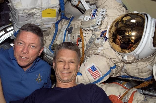 NASA image: Fossum and Sellers with Orlan Suit inside the DC during STS-121 / Expedition 13 joint operations