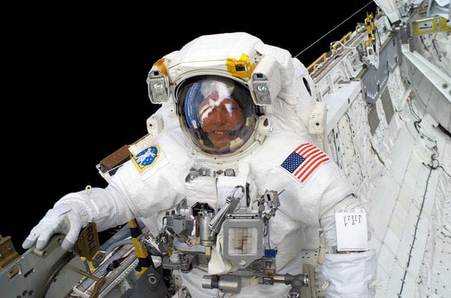 NASA image: Fossum smiles at the camera during EVA3 on STS-121 / Expedition 13 joint operations