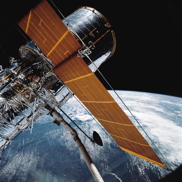 NASA image: STS-31 Hubble Space Telescope (HST) (SA & HGA deployed) is grappled by RMS