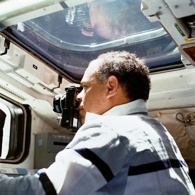 NASA image: STS-33 Commander Gregory uses a NIKON 35mm camera on OV-103's aft flight deck