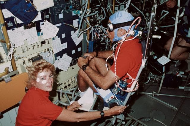 NASA image: STS-40 crewmembers, working in SLS-1 module, conduct Experiment No. 072