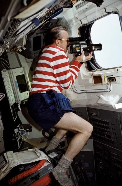 NASA image: STS-43 Mission Specialist (MS) Adamson uses camera on aft flight deck