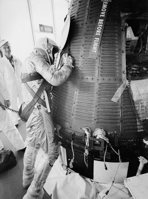 NASA image: Astronaut Alan Shepard in pressure suit with Freedom 7 capsule