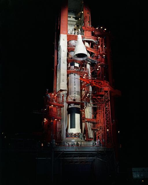 NASA image: Nighttime scene of Gemini spacecraft being hoisted to top of Pad 19