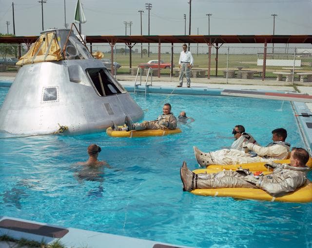 NASA image: Crew of the first manned Apollo mission practice water egress procedures