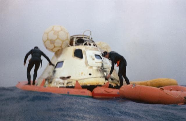 NASA image: Navy frogmen attach flotation collar to Apollo 7 command module