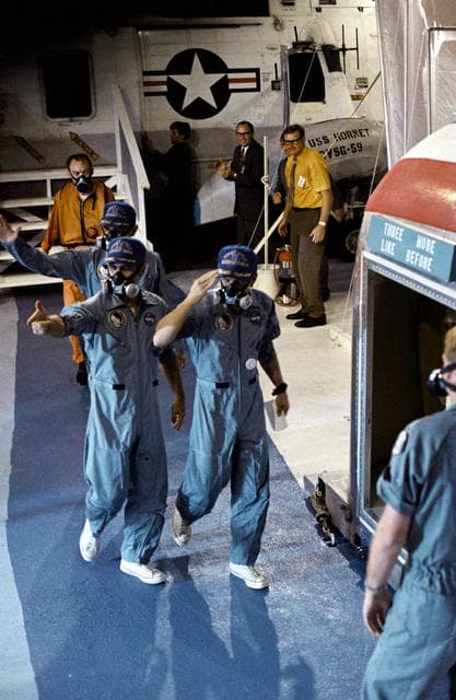 NASA image: U.S.S. Hornet crewmen greeted by crew of Apollo 12 lunar landing mission