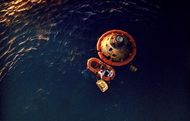 NASA image: Astronauts Stafford and Young await pickup by recovery helicopter