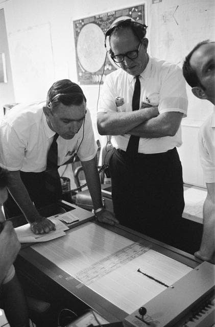 NASA image: Dr. Garry Latham studies seismometer tracings from the moon