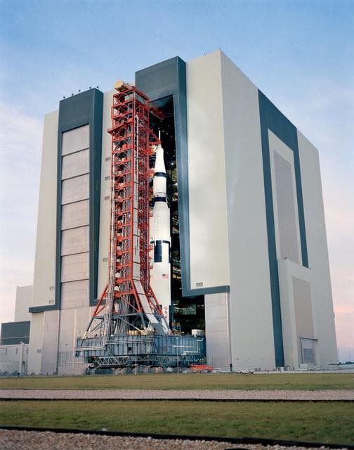 Ground level view of Apollo 14 space vehicle leaving VAB for launch pad