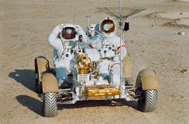 NASA image: Astronauts Scott and Irwin shown on Lunar Roving Vehicle at KSC