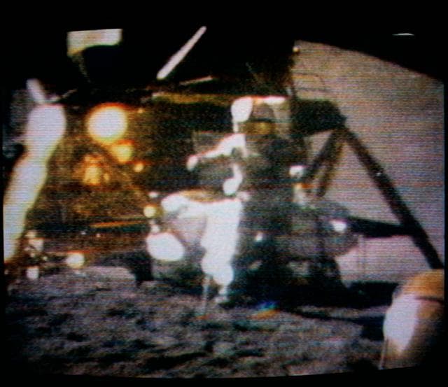 NASA image: Astronaut David Scott watching hammer and feather fall to lunar surface
