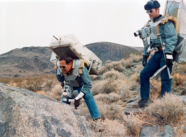 NASA image: ASTRONAUTS YOUNG AND DUKE - ROCK FORMATIONS - SIMULATED LUNAR TRAVERSE - CA