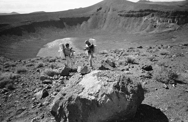NASA image: Apollo 17 Crewmembers - Rock Specimen Exam - Geological Field Trip - NV