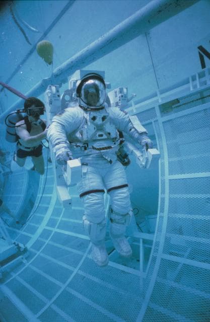 NASA image: Underwater EVA training in the WETF with astronauts Nelson and van Hoften