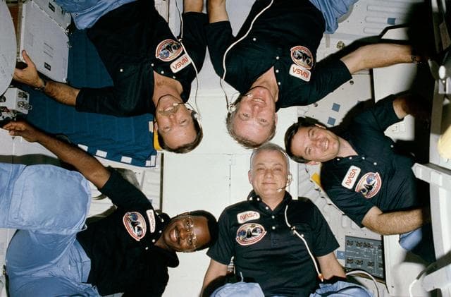 NASA image: "Star Burst" style crew portrait of 41-B crew taken in-cabin