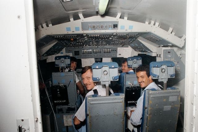 NASA image: STS 51-G crewmembers participate in training in crew compartment trainer