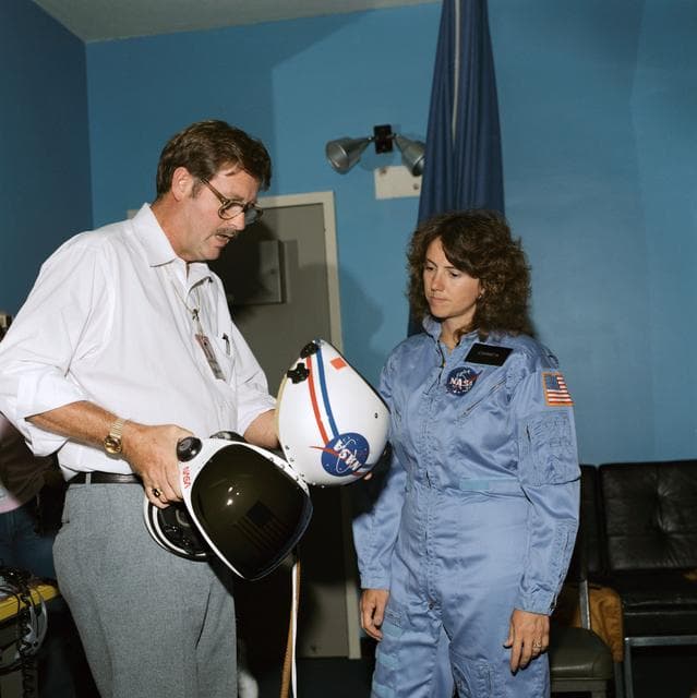 NASA image: Payload specialist Christa McAuliffe briefed on launch/entry helmets