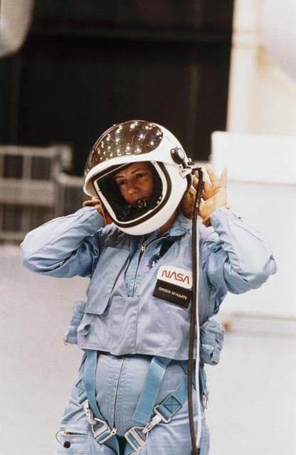 NASA image: Christa McAuliffe removing helmet after egress training