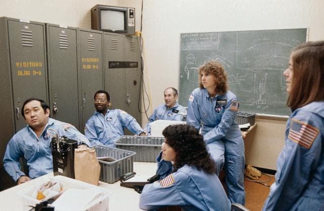 NASA image: STS 51-L crewmembers briefed during training session