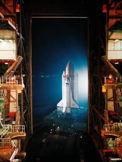NASA image: STS-26 Discovery, OV-103, rolls out of KSC VAB into darkness of the night