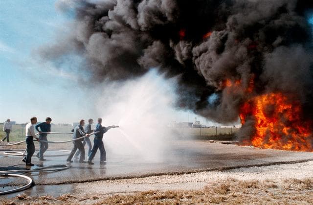 NASA image: STS-29 crewmembers participate in fire fighting training at JSC