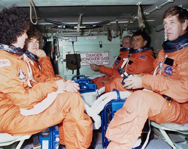 NASA image: STS-34 crewmembers sit in M1-13 APC during emergency egress training at KSC