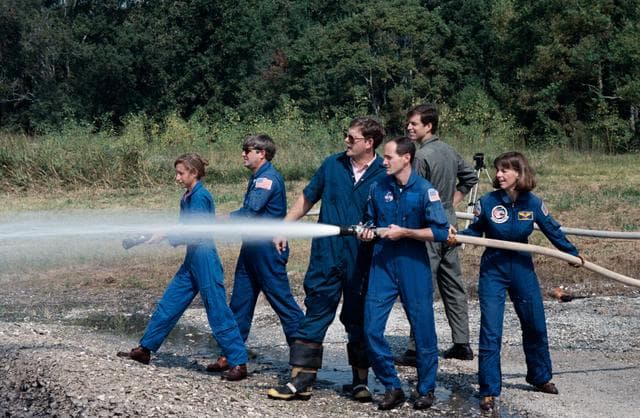 NASA image: STS-32 crewmembers use water hoses during fire fighting training at JSC