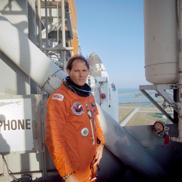 NASA image: STS-33 MS Carter on KSC LC Pad 39B 195 ft level with OV-103 in background
