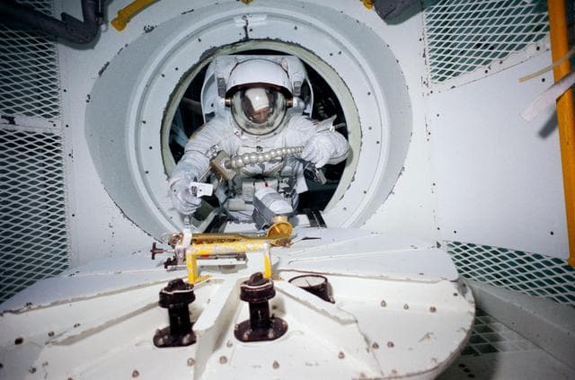 NASA image: STS-31 MS Sullivan exits airlock mockup during JSC WETF underwater simulation