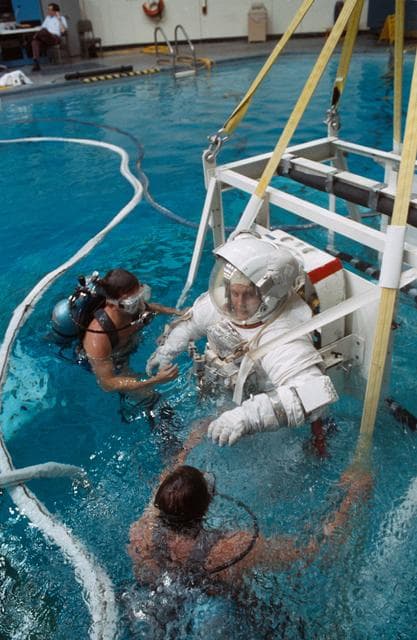 NASA image: STS-48 MS Buchli, in EMU, is lowered into JSC's WETF pool for EVA simulation