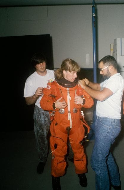 NASA image: STS-47 MS Davis dons LES with technicians' help prior to JSC bailout training